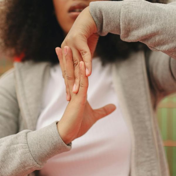 Close up of person stretching hands towards the sky